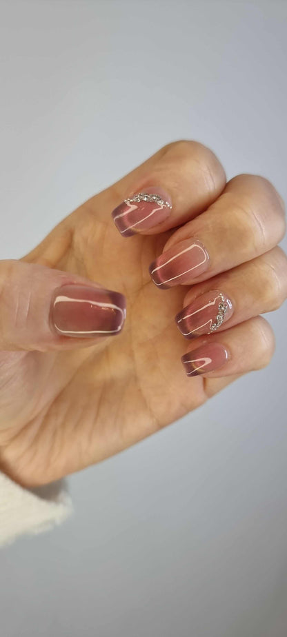 Close-up of Souq Secrets long, square-shaped press-on nails.