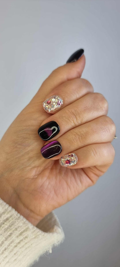 Set of Yas Island false nails with a dark, abstract design, showcasing the full manicure.