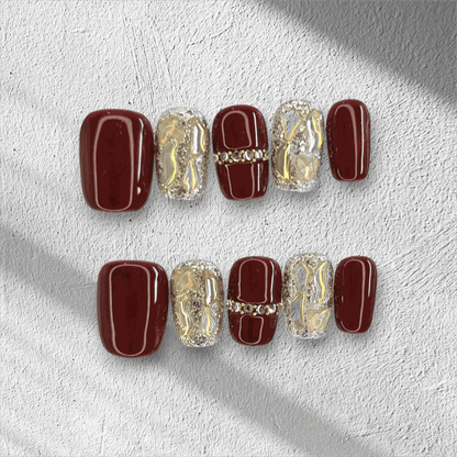 Full set of the Zaina red short square press-on nails, some with designs.