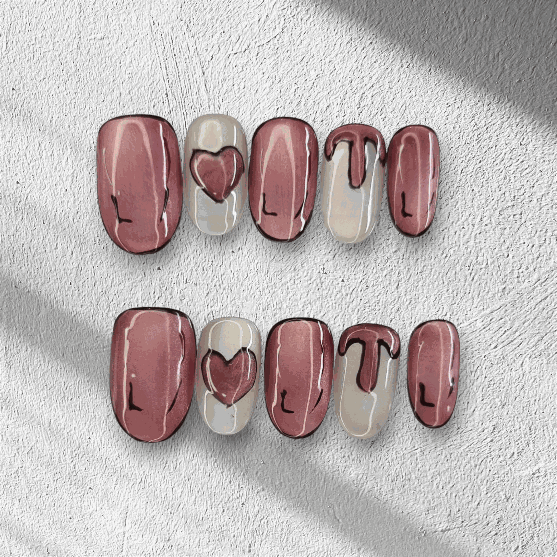 Full set of Zayed Zeal false nails with a unique swirled or marbled design, displayed.