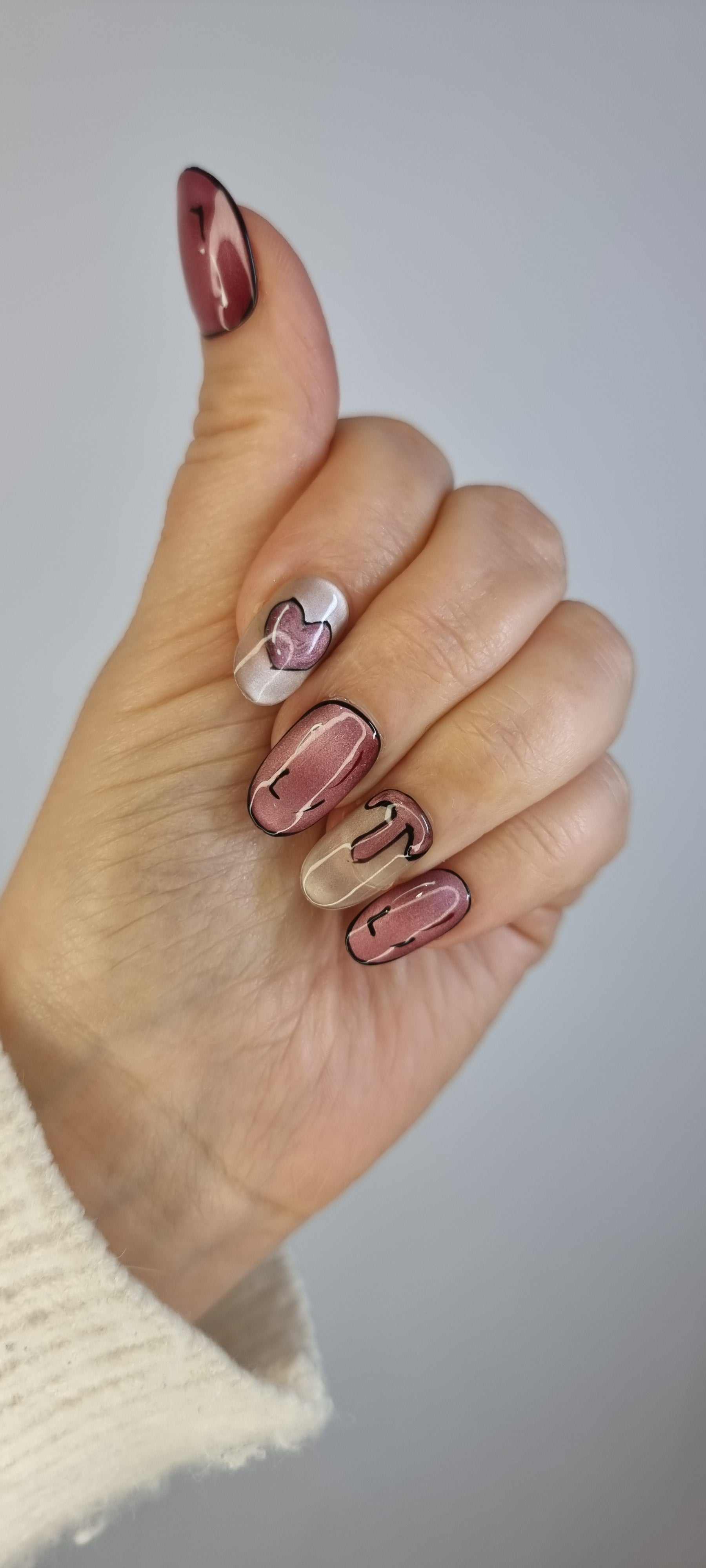 Set of Zayed Zeal false nails with a unique swirled or marbled design.