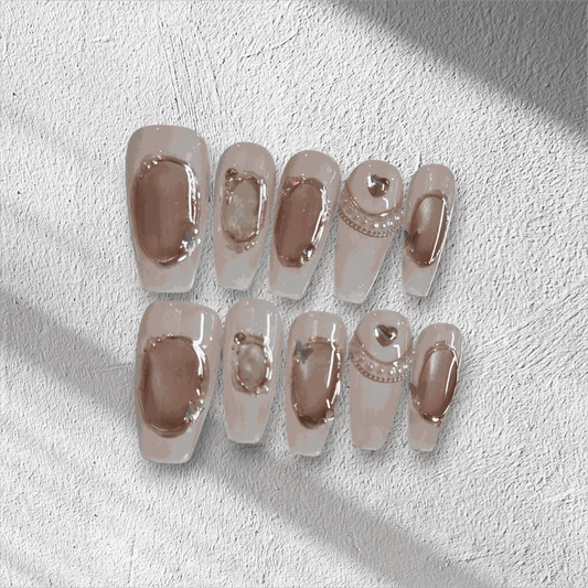 Full set of Zaynah Long neutral-toned, glossy coffin-shaped press-on nails in the box.
