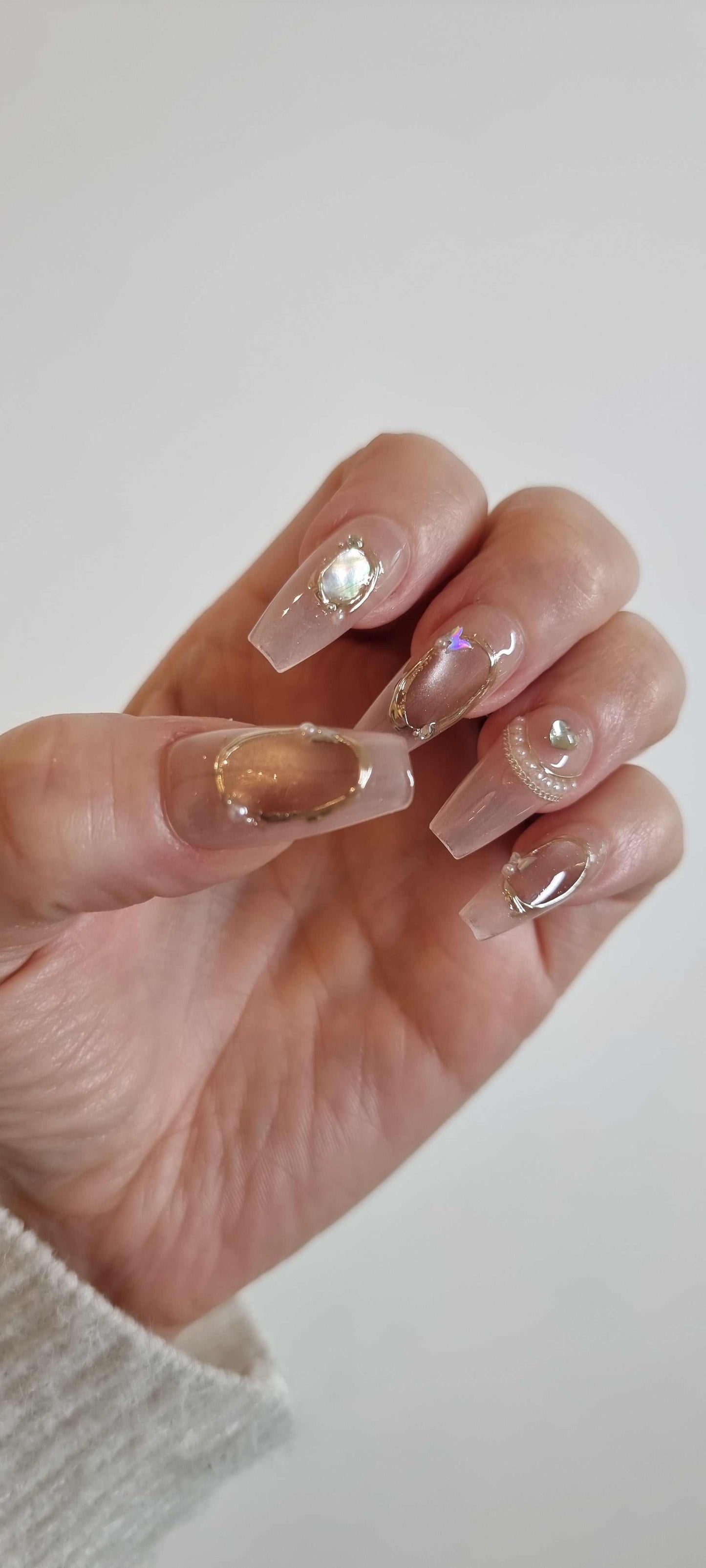 Set of Zaynah Long neutral-toned, glossy coffin-shaped press-on nails.