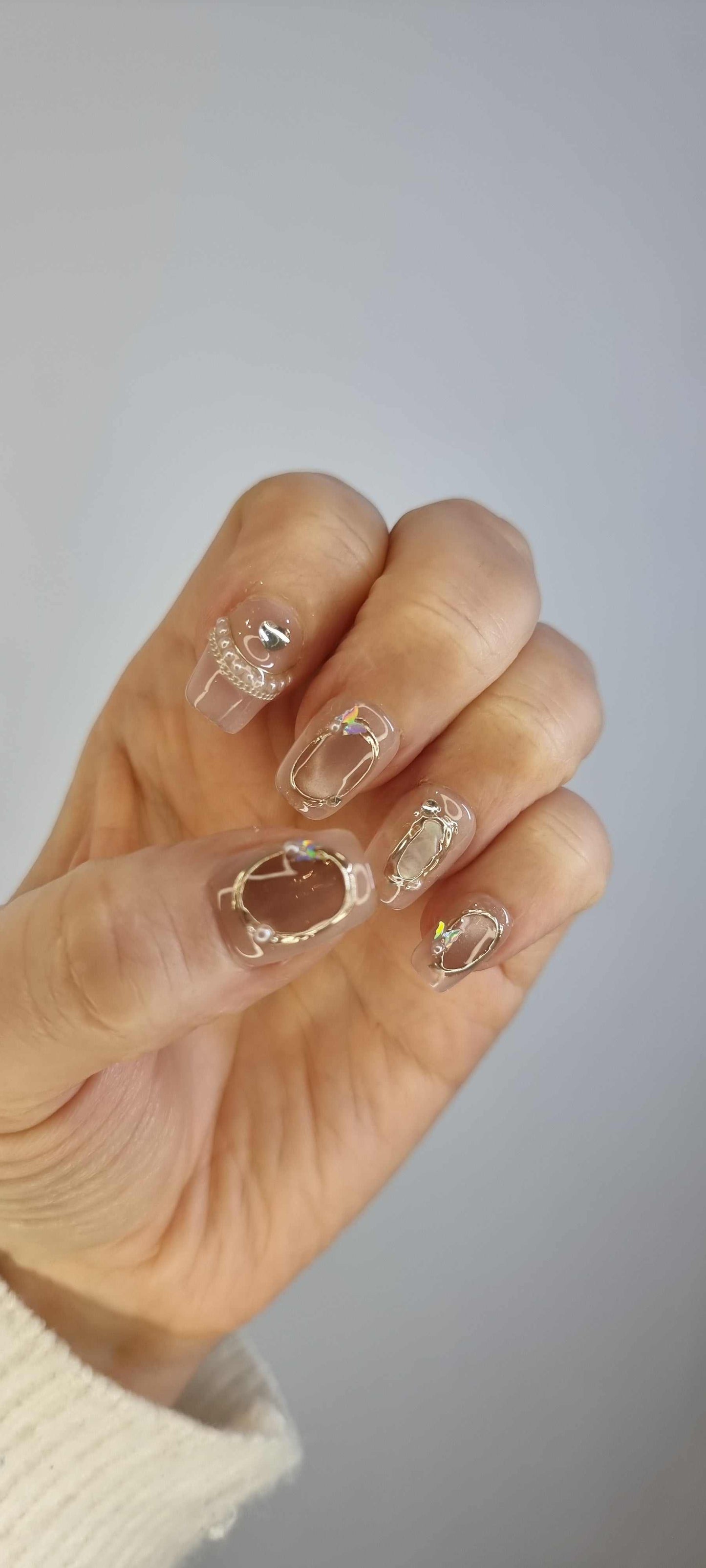 Set of Zaynah Short neutral-toned, glossy coffin-shaped press-on nails.