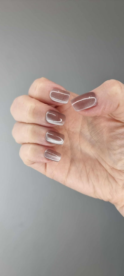 Close-up of a set of Zubaida nude beige false press-on nails with a subtle design.